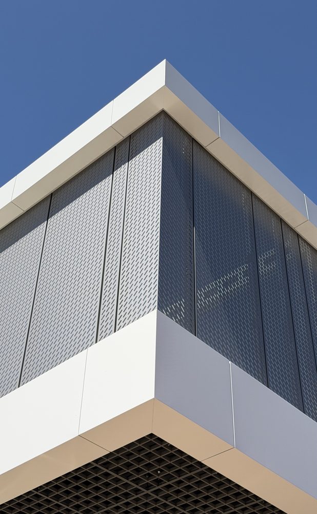 White ACM corner with a perforated screen